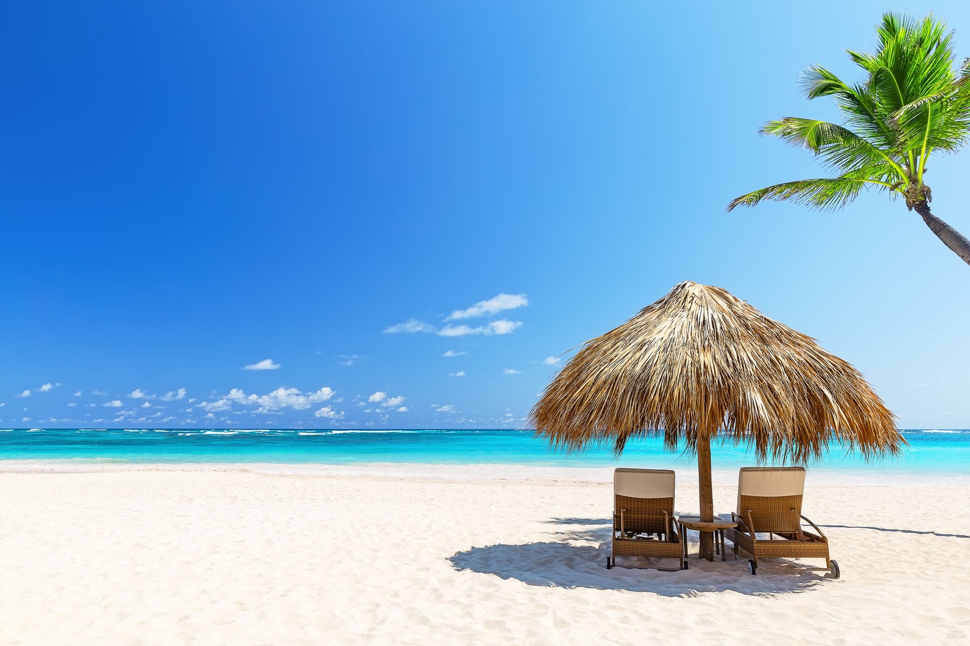 Two empty beach chairs on a summer sunny day at the beach