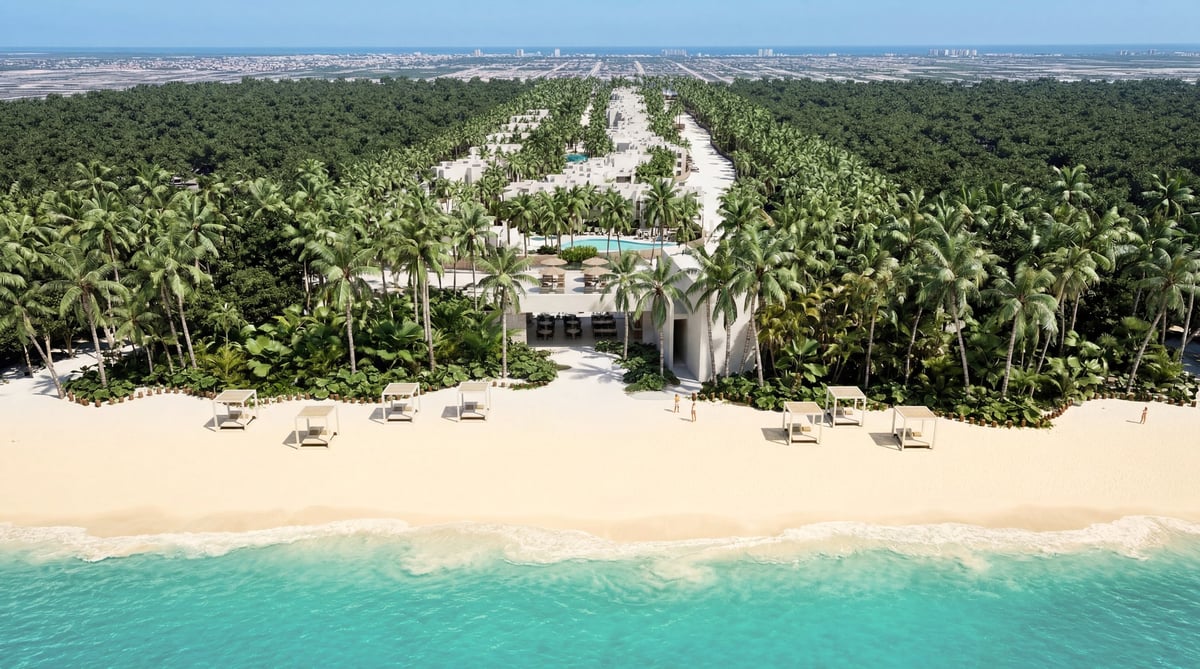 Vista aérea del desarrollo frente al mar, con playa, palmeras y edificio principal entre vegetación tropical