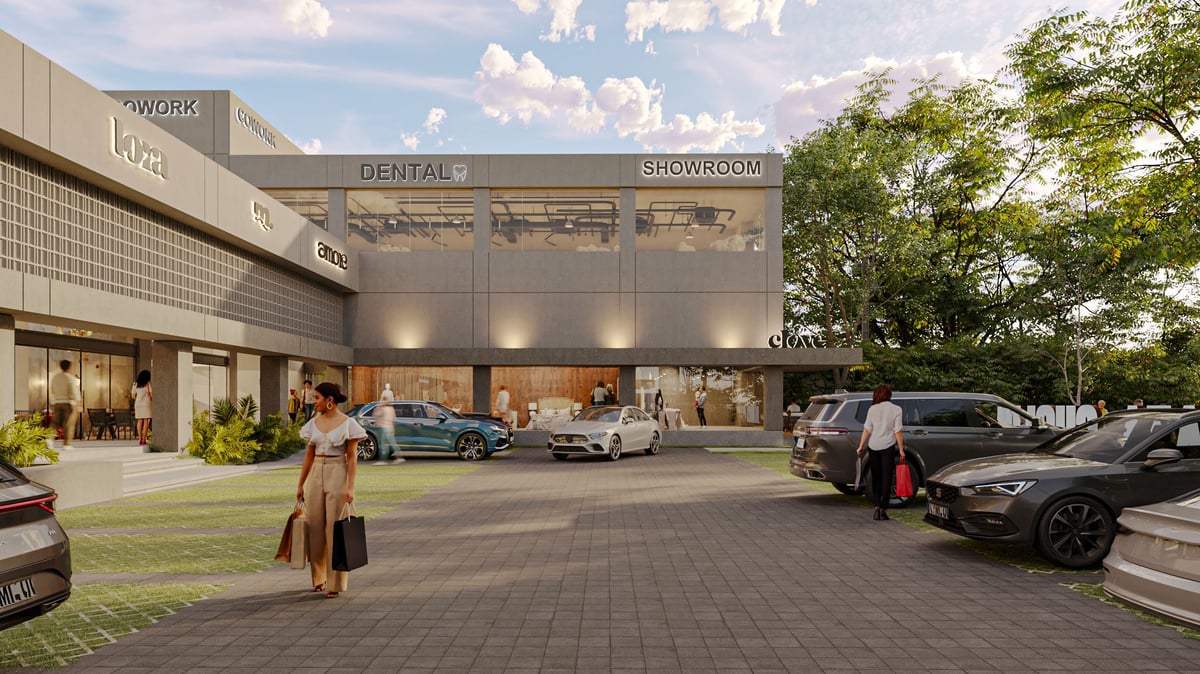 Modern commercial building with dental showroom and luxury car dealership, featuring parked vehicles and landscaping