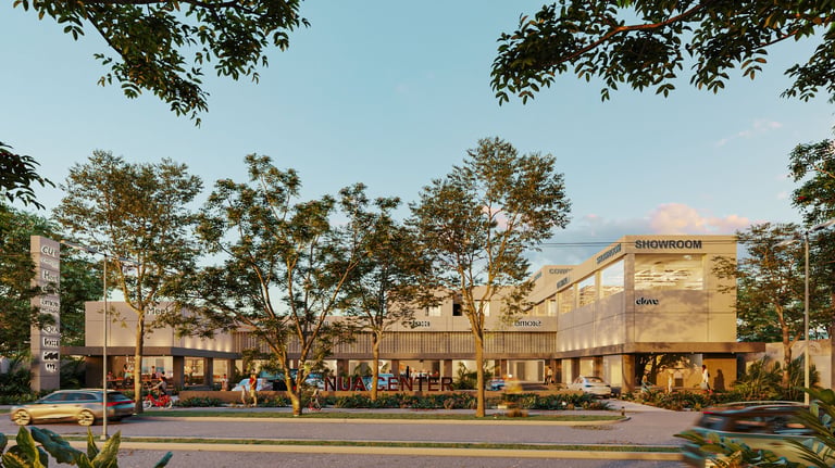 Modern commercial building with glass storefront and outdoor seating area, surrounded by trees and greenery at dusk