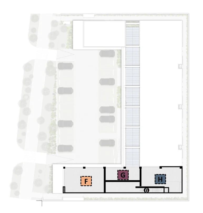 Architectural floor plan showing building layout with parking spaces, landscaping, and interior rooms with fixtures.
